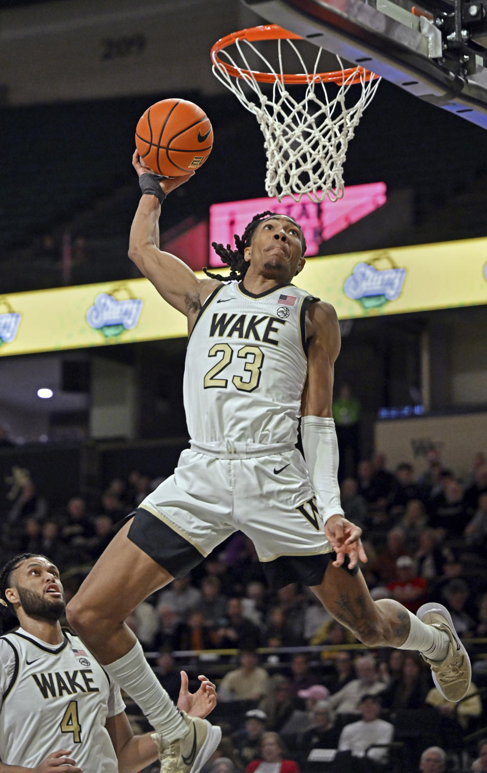 FILE - Wake Forest's Hunter Sallis (23) throws down a dunk on a alley-oop from Boopie Miller during an NCAA college basketball game against Presbyterian, Thursday, Dec. 21, 2023, in Winston-Salem, N.C. Hunter Sallis was named newcomer of the year in the Atlantic Coast Conference in voting released Tuesday, March 12, 2024. (Walt Unks/Winston-Salem Journal via AP, File)