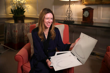 Clare Waight Keller, designer at Givenchy, holds sketches as she gives an interview the day after Meghan Markle walked down the aisle of St George's Chapel in Windsor and married Prince Harry wearing the dress that she created, in Kensington Palace, London, Britain, May 20, 2018. REUTERS/Hannah McKay/Pool