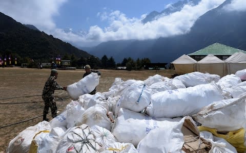 Nepali Army personnel collect waste from Mount Everest at Namche Bazar in Solukhumbu district - Credit: AFP