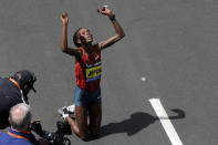 Rita Jeptoo, of Kenya, celebrates her win in the women's division of the 118th Boston Marathon Monday, April 21, 2014 in Boston. (AP Photo/Charles Krupa)