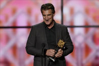 CORRECTS TO NFL DEFENSIVE ROOKIE, NOT DEFENSIVE PLAYER - John Bosa accepts the AP Defensive Rookie of the Year award for is son San Francisco 49ers' Nick Bosa at the NFL Honors football award show Saturday, Feb. 1, 2020, in Miami. (AP Photo/David J. Phillip)