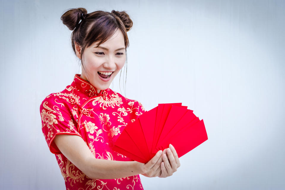 Asian woman holding red envelope, woman wear cheongsam, chinese new year