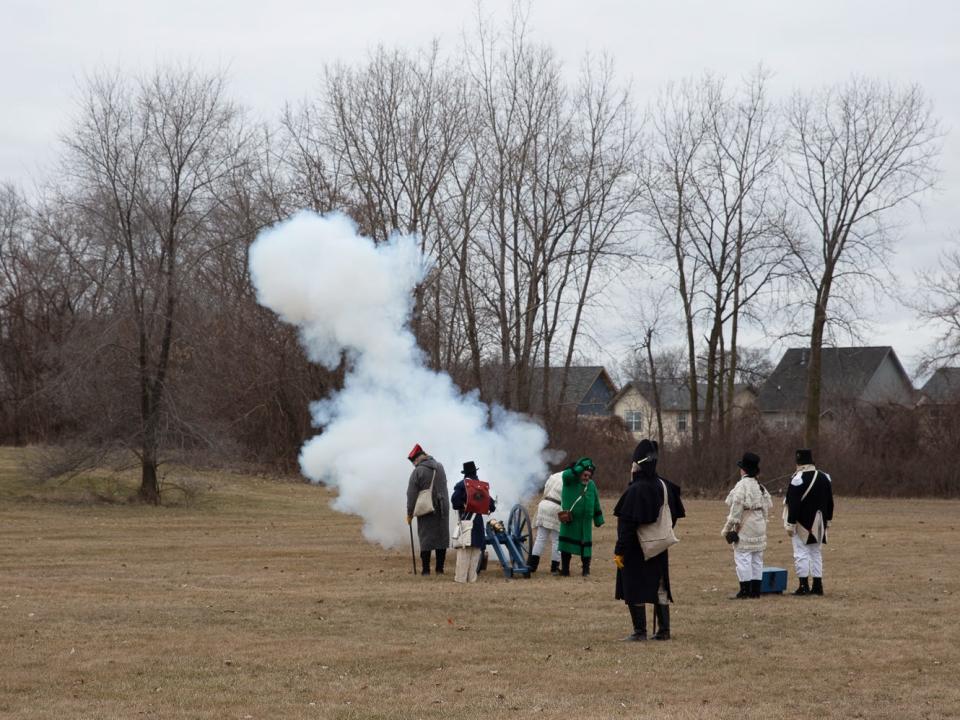 A replica cannon with blank ammunition is fired during a tactical demonstration Saturday, Jan. 21, 2023, at the River Raisin Battlefield National Park in Monroe.