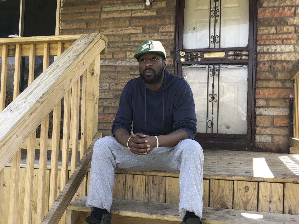 Kevin Houston sits on the front steps of his home, May 9, 2023, in Highland Park, Mich., a small enclave of Detroit that is considering chapter 9 bankruptcy due to a $20 million debt to a regional water authority. Houston grew up in Highland Park and acknowledges that the city has too many vacant houses and overgrown lots. He says Highland Park is "not a bad place to live" but "it's not the best." (AP Photo/Corey Williams)