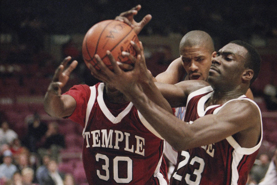 FILE - In this Dec. 29, 1993, file photo, Temple's Jason Ivey (30) and Aaron McKie (23) struggle for possession as Fairleigh Dickinson's Donald Osbourne approaches during the consolation game of the ECAC Holiday Festival Tournament in New York's Madison Square Garden. McKie is just the third head coach for Temple since Hall of Famer John Chaney was hired in 1982. (AP Photo/Mike Albans, File)