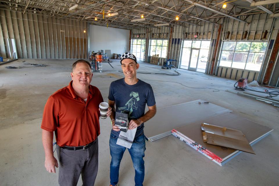 Jeff Sarver, left, franchisee of the Booskerdoo Middletown location, and James Caverly, co-founder and CEO of Booskerdoo Coffee and Baking Co., stand in September 2022 inside the former Sears Auto Center building in Middletown, which they were converting to Booskerdoo.