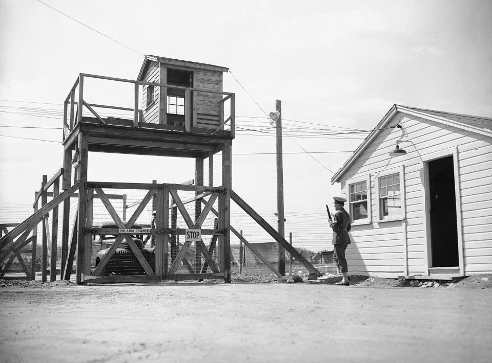 <p>The main entrance of the Enemy Alien Concentration Camp at Fort Devons, Ayer, Massachusetts on March 31, 1942. Trucks and people have to be admitted through two rows of barbed-wire before entering the camp. (AP Photo/JWG) </p>