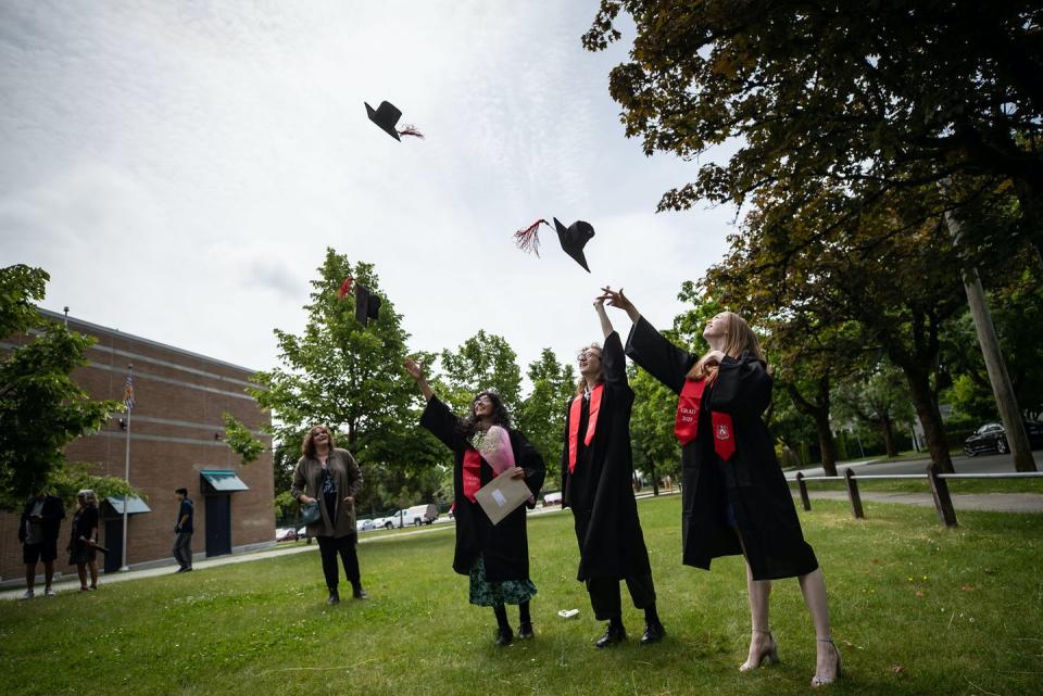 <span class="caption">Students toss their caps into the air while posing for family photos after a graduation ceremony at a Vancouver high school in June 2020.</span> <span class="attribution"><span class="source">THE CANADIAN PRESS/Darryl Dyck</span></span>