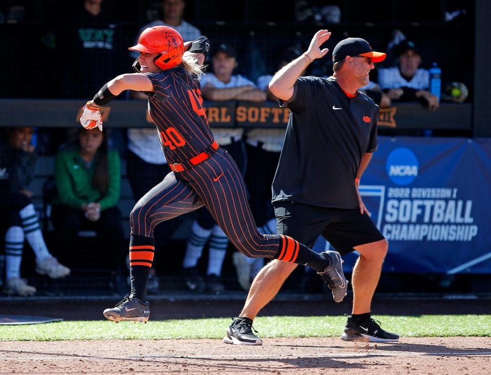 Oklahoma State's Miranda Elish (40) celebrates her home run in the sixth inning with coach Kenny Gajewski in a 2-0 win against North Texas on Sunday in Stillwater.