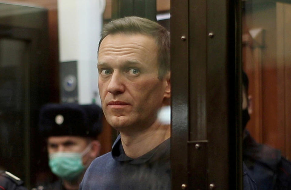 Image: Russian opposition leader Alexei Navalny, who is accused of flouting the terms of a suspended sentence for embezzlement, inside a defendant dock during the announcement of a court verdict in Moscow, Russia (Simonovsky District Court / Reuters file)