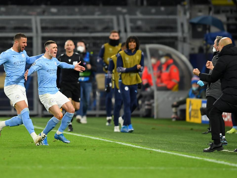 Phil Foden runs to celebrate with coach Pep Guardiola after scoring for City (Getty Images)