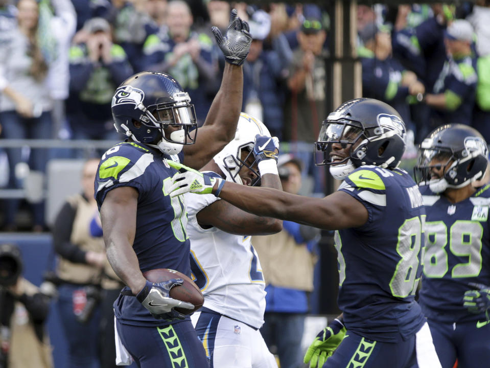 Seattle Seahawks' Jaron Brown, left, celebrates his touchdown against the Los Angeles Chargers with David Moore during the first half of an NFL football game, Sunday, Nov. 4, 2018, in Seattle. (AP Photo/Scott Eklund)