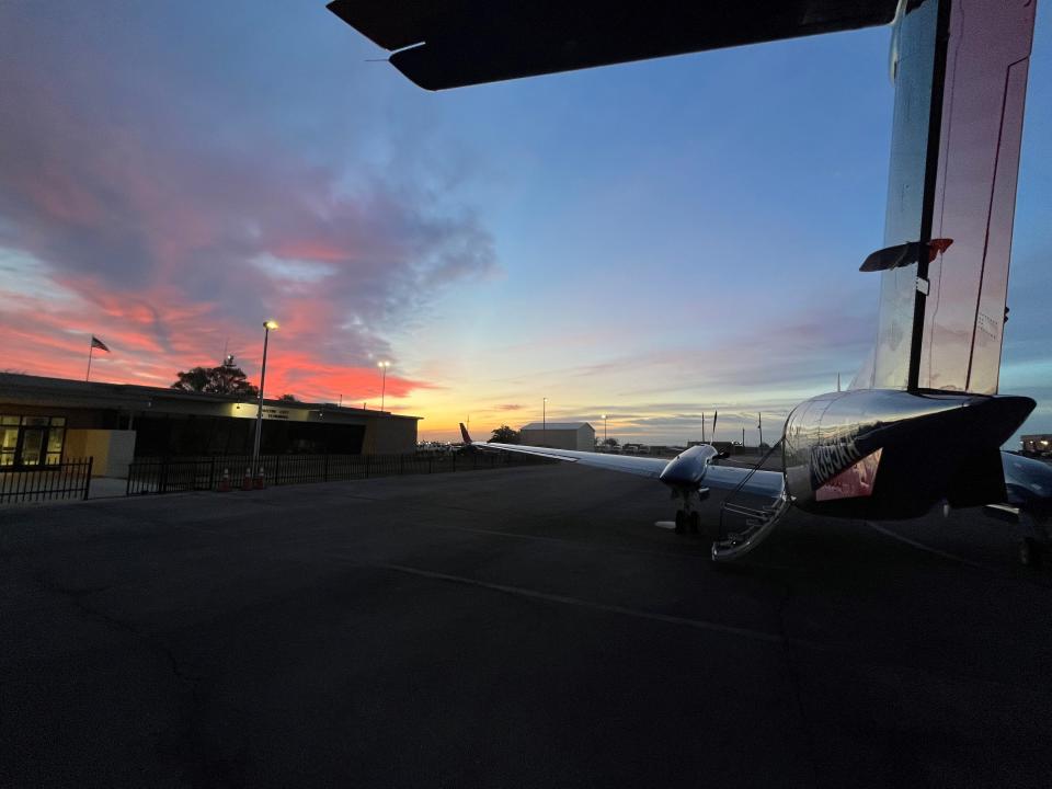 The sun sets as an Advanced Air plane rests at the Cavern City Air Terminal in Carlsbad.