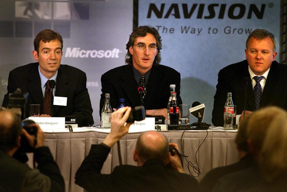 Doug Burgum (C) Microsoft senior vice president, is flanked by two of the Danish software company Navision's principal shareholders Preben Damgaard (L) and Jesper Balser (R) at a press conference 07 May 2002 in Copenhagen, where it was announced, that Microsoft has agreed to buy Navision in a 1.47 billion euro in stock and cash deal. Navision, which has about 1,300 employees in 30 countries, will be Microsoft's center of development and operations for Europe, the Middle East and Africa.