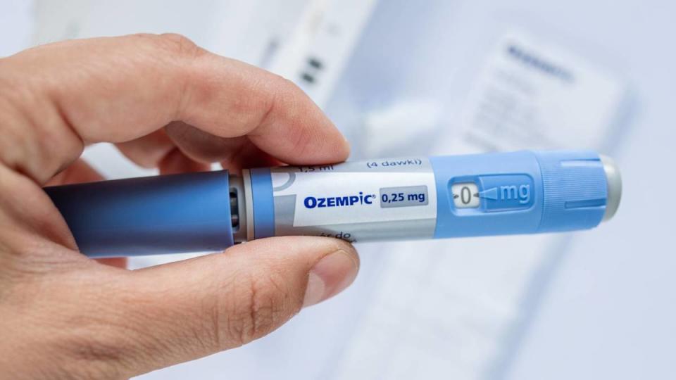 An Ozempic injection device is held.<p>Shutterstock</p>