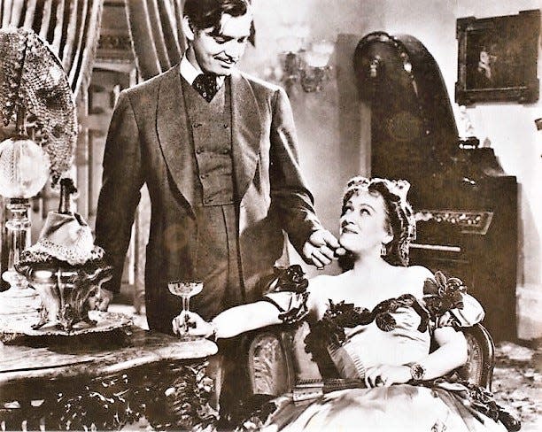 Actor Clark Gable as Rhett Butler with Ona Munson as Belle Watling in a scene from the movie version of "Gone With the Wind."