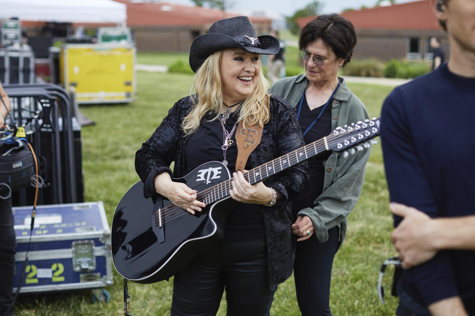 This image released by Paramount+ shows Melissa Etheridge, foreground and Linda Wallem during the filming of the docuseries "Melissa Etheridge: I'm Not Broken." (James Moes/Paramount+ via AP)