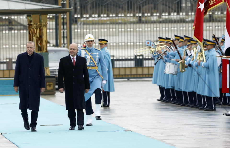 Turkey's President Recep Tayyip Erdogan, left, and Iraq's President Barham Salih inspect a military honour guard before their talks in Ankara, Turkey, Thursday, Jan. 3, 2019. The two were expected to discus bilateral and regional issues, including Syria.(AP Photo/Burhan Ozbilici)