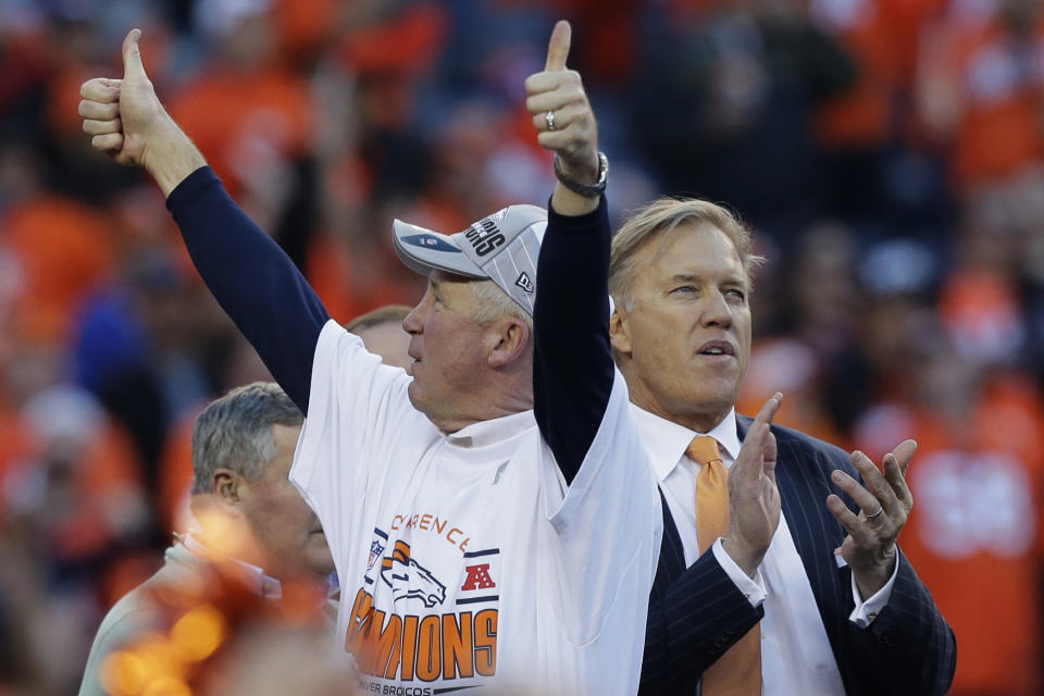 Denver Broncos head coach John Fox and Vice President John Elway celebrate during the trophy presentation after the AFC Championship NFL playoff football game against the New England Patriots in Denver, Sunday, Jan. 19, 2014. The Broncos defeated the Patriots 26-16 to advance to the Super Bowl. (AP Photo/Julie Jacobson)