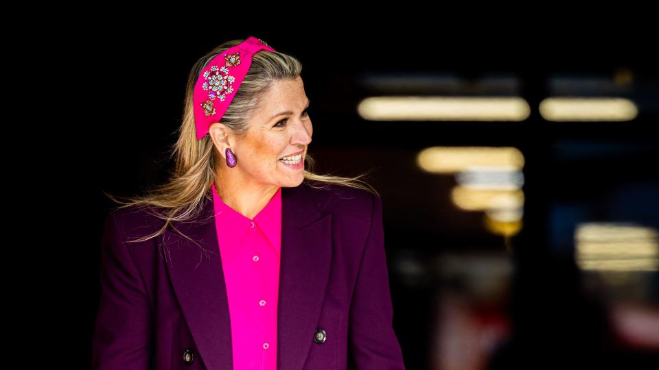 Queen Maxima wearing headband with colour clashing purple suit