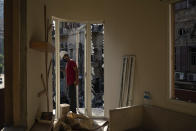 An engineer inspects a residential building heavily damaged in last week's explosion that hit the seaport of Beirut, Lebanon, Tuesday, Aug. 11, 2020. (AP Photo/Felipe Dana)