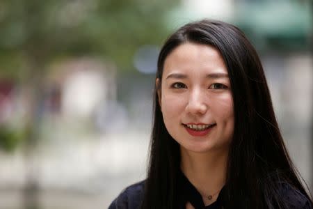 Qin Lijuan, a senior wealth management consultant and manager at CreditEase, poses for pictures in Chengdu, Sichuan province, China, September 13, 2017. Picture taken September 13, 2017. REUTERS/John Ruwitch