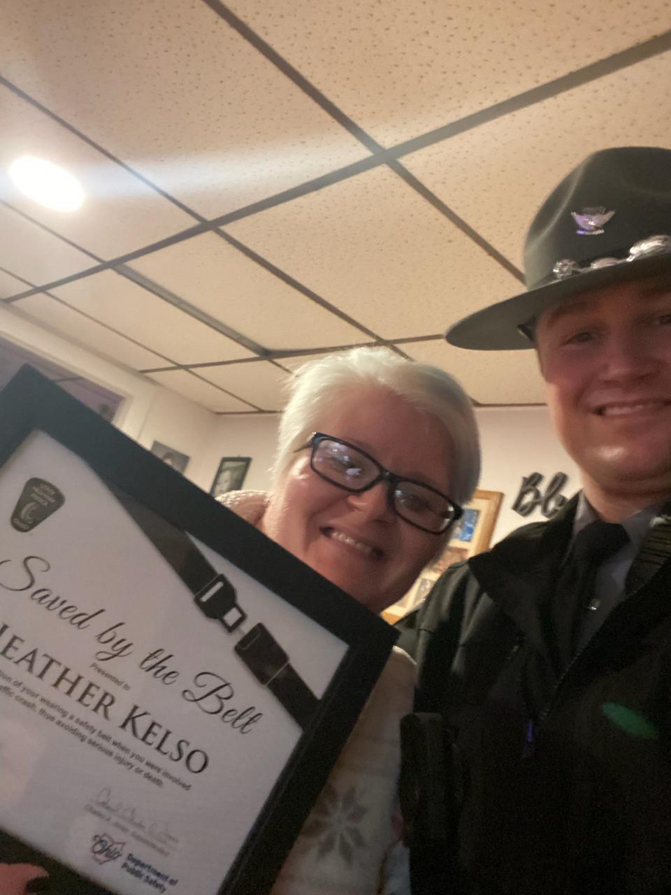 Heather Kelso poses for a selfie with Trooper Nagel of the Ohio State Highway Patrol Cambridge Post after receiving her Saved by the Belt certificate. Kelso was involved in an August accident where her seat belt saved her life.