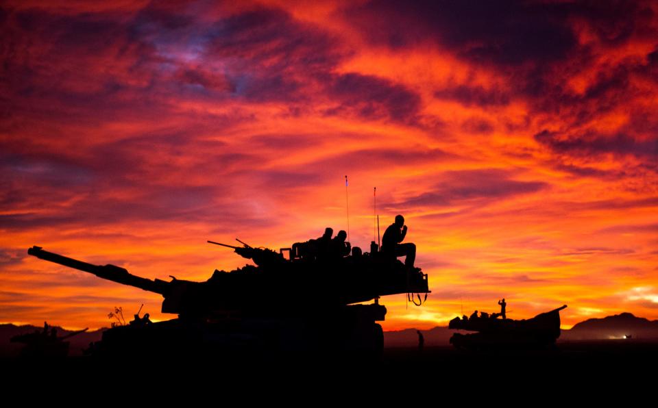 A silhouette of a U.S. Marine Corps M1A1 Abrams Tank Crew with the 1st Tanks Bravo Company 3rd Battalion 4 Marine Regiment at Twentynine Palms Marine Corps Base, California 23 Jan, 2013.