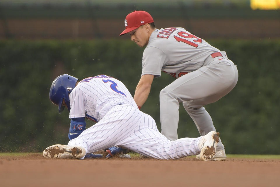 Chicago Cubs Nico Hoerner (2) dives safely into second with a late tag by St. Louis Cardinals second baseman Tommy Edman (19) during the fourth inning of a baseball game, Sunday, June 5, 2022, at Wrigley Field in Chicago. (AP Photo/Mark Black)