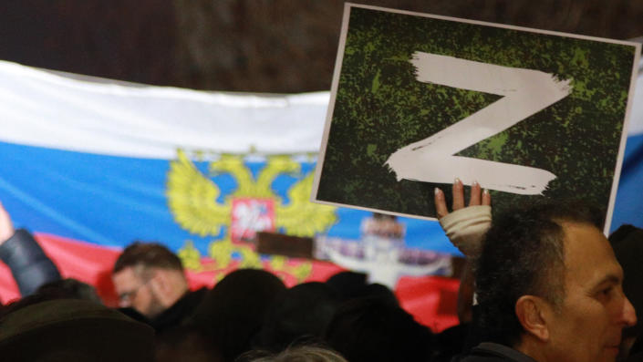 A protester holds a sign marked 