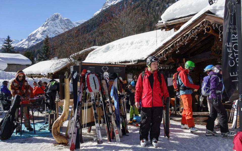 Skiers outside traditional Alpine ski restaurant Le Cafe Comptoir in Vallorcine - PBimages / Alamy Stock Photo 