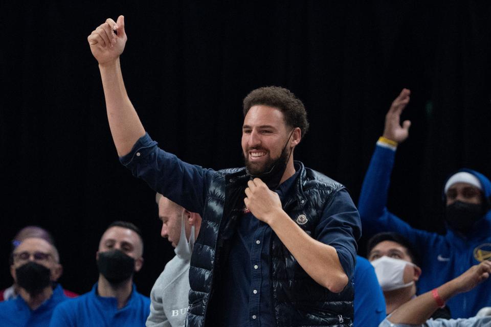 Golden State Warriors guard Klay Thompson (11) celebrates on the bench against the LA Clippers during the second quarter at Chase Center.