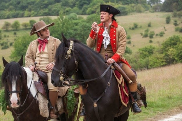 two characters riding horseback in clothes from the 1800s