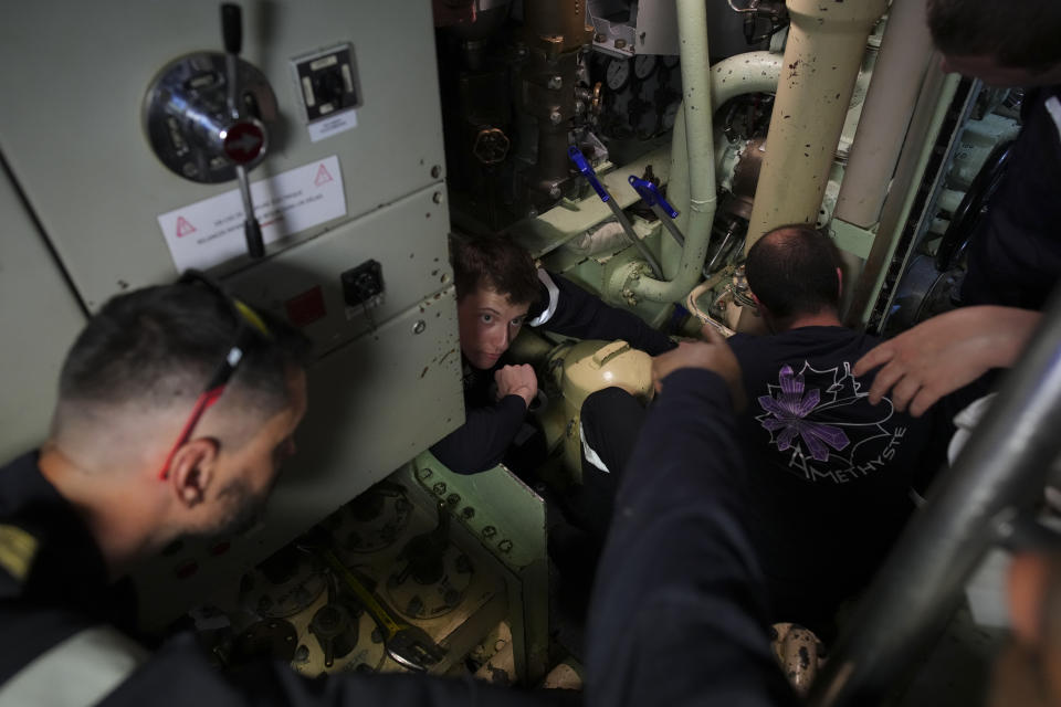 Sailors prepare a French Rubis-class submarine at the Toulon naval base in southern France, Monday, April 15, 2024. The nuclear powered submarine will be guarding France's Charles de Gaulle aircraft carrier during training exercises dubbed Neptune Strike in the Mediterranean with the 32-nation NATO military alliance. (AP Photo/Daniel Cole)