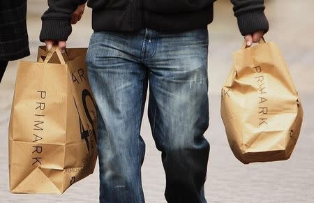 A shopper carries Primark bags in Blackpool,northern England, November 14, 2009. REUTERS/Phil Noble