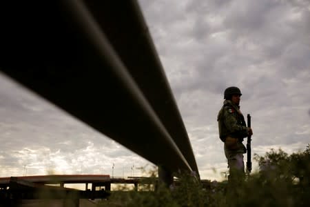 A member of the national guard keeps watch at the border with the U.S., as seen from Ciudad Juarez