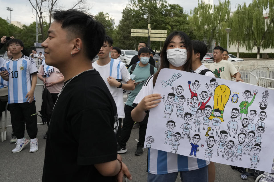 Chinese fans wait to catch a glimpse of the soccer superstar Lionel Messi in Beijing, Tuesday, June 13, 2023. Argentina is scheduled to play Australia in a friendly match in China's capital on Thursday. (AP Photo/Ng Han Guan)