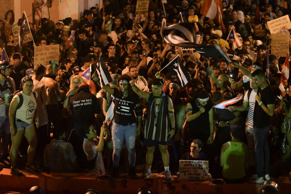 Demonstrators protest against governor Ricardo Rossello, in San Juan, Puerto Rico, Friday, July 19, 2019. Protesters are demanding Rossello step down for his involvement in a private chat in which he used profanities to describe an ex-New York City councilwoman and a federal control board overseeing the island's finance. (AP Photo/Carlos Giusti)