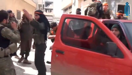 A still image taken from a video uploaded on social media on March 22, 2017, purports to show Tahrir al-Sham rebel fighters getting into a pick-up truck, said to be in Soran district, near Hama, Syria. Social Media Website via Reuters TV