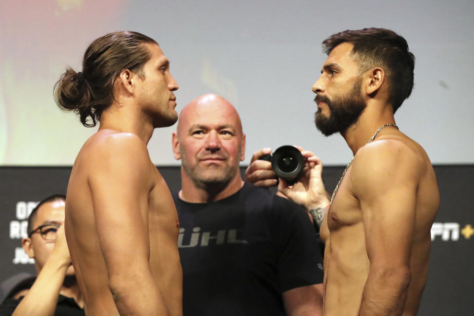 Yair Rodriguez, right, and Brian Ortega face off during a ceremonial weigh-in for the UFC on ABC 3 mixed martial arts event, Friday, July 15, 2022, in Elmont, NY. (AP Photo/Gregory Payan)