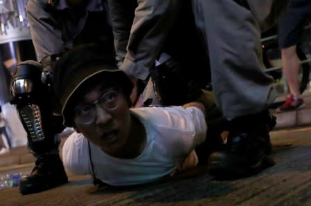 Riot police officers detain an anti-government protester at Mongkok, in Hong Kong