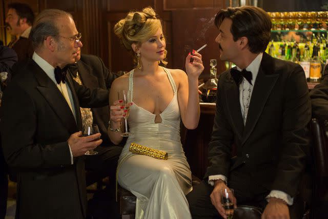 Moviestore/Shutterstock Gary Craig, Jennifer Lawrence and Jack Huston in 'American Hustle,' 2013