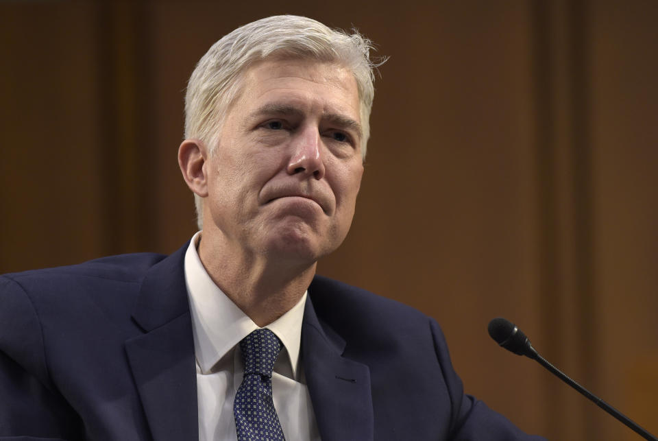 FILE - In this Wednesday, March 22, 2017, file photo, Supreme Court Justice nominee Neil Gorsuch listens as he is asked a question by Sen. Mazie Hirono, D-Hawaii, on Capitol Hill in Washington, during his confirmation hearing before the Senate Judiciary Committee. Democratic Sen. Joe Donnelly says he'll support the nomination of Gorsuch to the U.S. Supreme Court. The Indiana Democrat announced his support on Sunday, April 2, 2017, for President Donald Trump’s pick, calling Gorsuch "a qualified jurist who will base his decisions on his understanding of the law and is well-respected among his peers." Donnelly faces a tough re-election in 2018. (AP Photo/Susan Walsh, File)