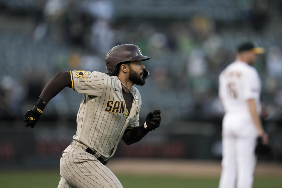 San Diego Padres' Fernando Tatis Jr. runs the bases after hitting a solo home run against Oakland Athletics pitcher Sean Newcomb, back right, during the first inning of a baseball game Friday, Sept. 15, 2023, in Oakland, Calif. (AP Photo/Godofredo A. Vásquez)