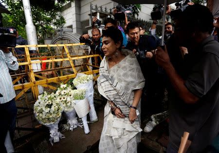 A woman reacts after placing flowers at a makeshift memorial near the site, to pay tribute to the victims of the attack on the Holey Artisan Bakery and the O'Kitchen Restaurant, in Dhaka, Bangladesh, July 3, 2016. REUTERS/Adnan Abidi