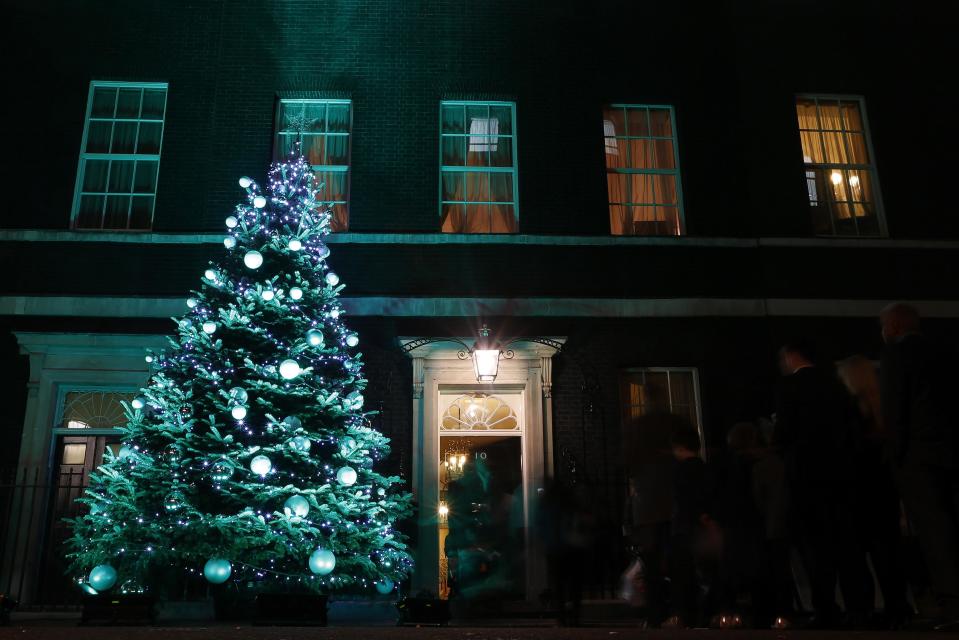 Guests from the 10 Downing Street Christmas party mill around outside after the Christmas tree lights were switched on in central London