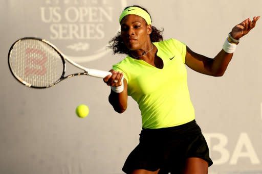 Serena Williams returns a shot to Chanelle Scheepers of South Africa during the Bank of the West Classic at Stanford University Taube Family Tennis Stadium on July 13 in Stanford, California. Williams fought off fatigue to post a 6-4, 6-0 win