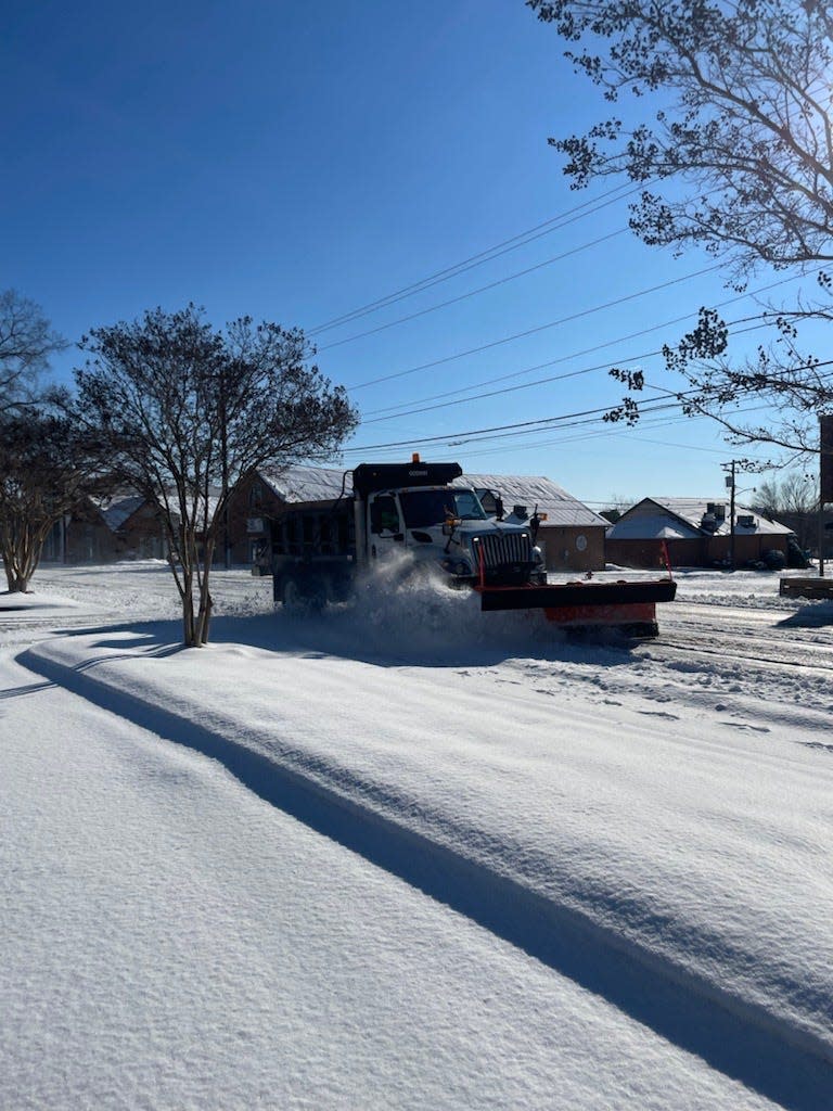 Spartanburg city crews plow Kennedy Street near Pine Street Monday morning. Most streets are still covered with snow and ice, officials said.