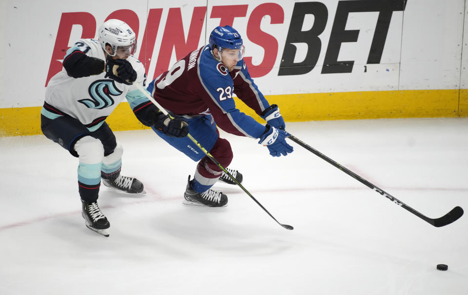 Colorado Avalanche center Nathan MacKinnon, right, drives past Seattle Kraken center Alex Wennberg in the third period of Game 7 of an NHL first-round playoff series Sunday, April 30, 2023, in Denver. The Kraken won 2-1 to advance to the next round. (AP Photo/David Zalubowski)