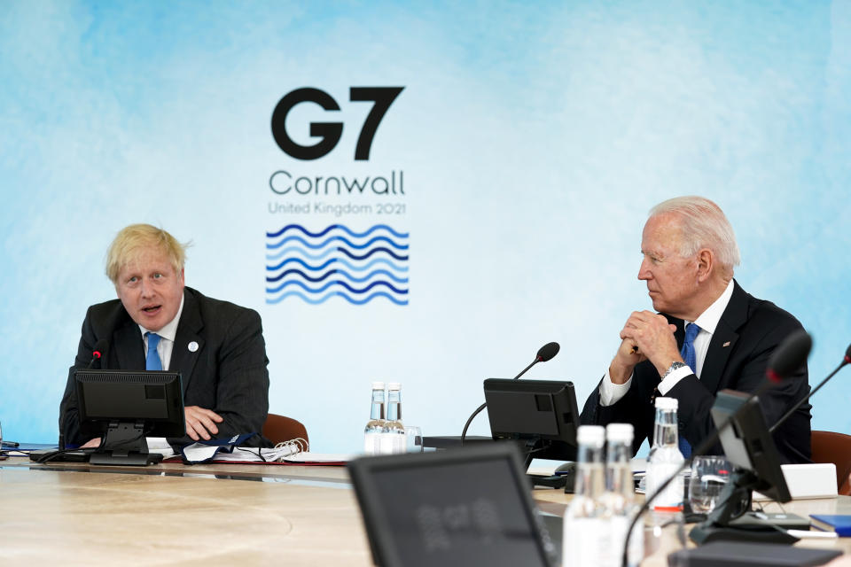 British Prime Minister Boris Johnson, left, speaks as President Joe Biden listens during the G-7 summit at the Carbis Bay Hotel in Carbis Bay, St. Ives, Cornwall, England, Friday, June 11, 2021. Leaders of the G-7 begin their first of three days of meetings on Friday, in which they will discuss COVID-19, climate, foreign policy and the economy. (Kevin Lamarque/Pool via AP)